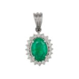 AN EMERALD AND DIAMOND CLUSTER PENDANT set with an oval cut emerald of approximately 3.35 carats ...