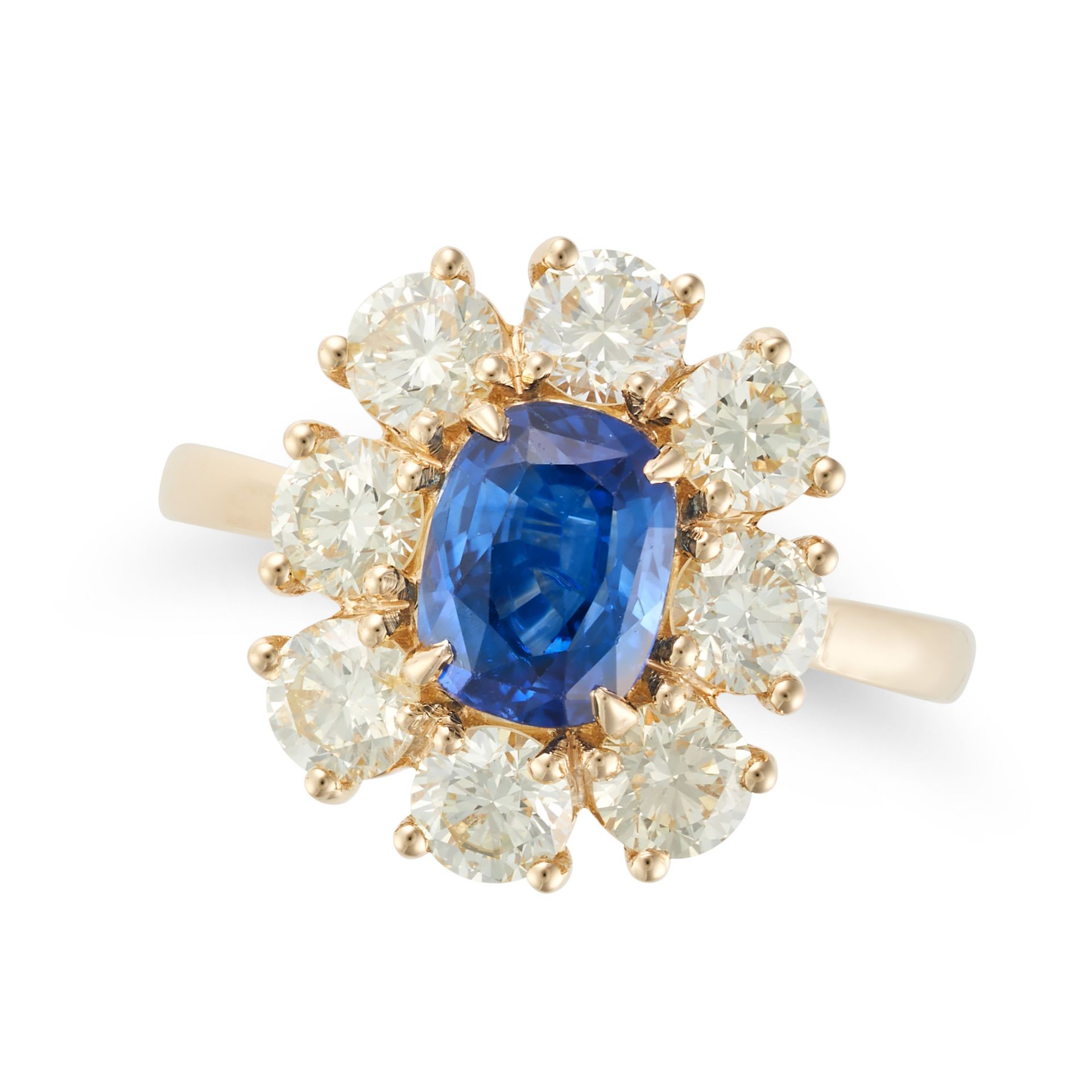 A SAPPHIRE AND DIAMOND CLUSTER RING in 18ct yellow gold, set with a cushion cut sapphire of appro...