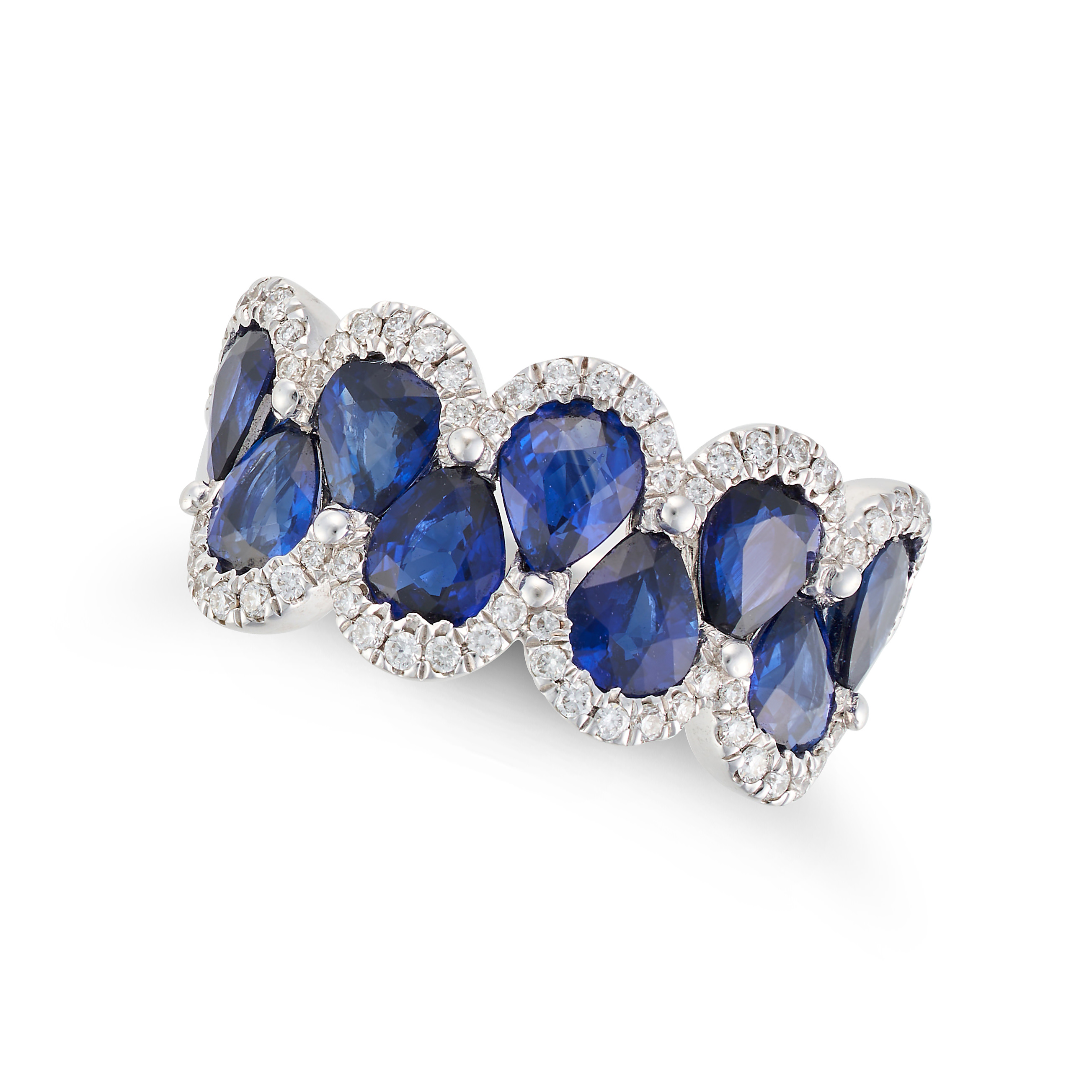 A SAPPHIRE AND DIAMOND RING in 18ct white gold, set with pear cut sapphires accented by round cut...