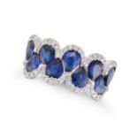 A SAPPHIRE AND DIAMOND RING in 18ct white gold, set with pear cut sapphires accented by round cut...