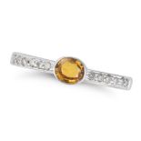 A YELLOW SAPPHIRE AND DIAMOND RING set with an oval cut yellow sapphire accented by round cut dia...