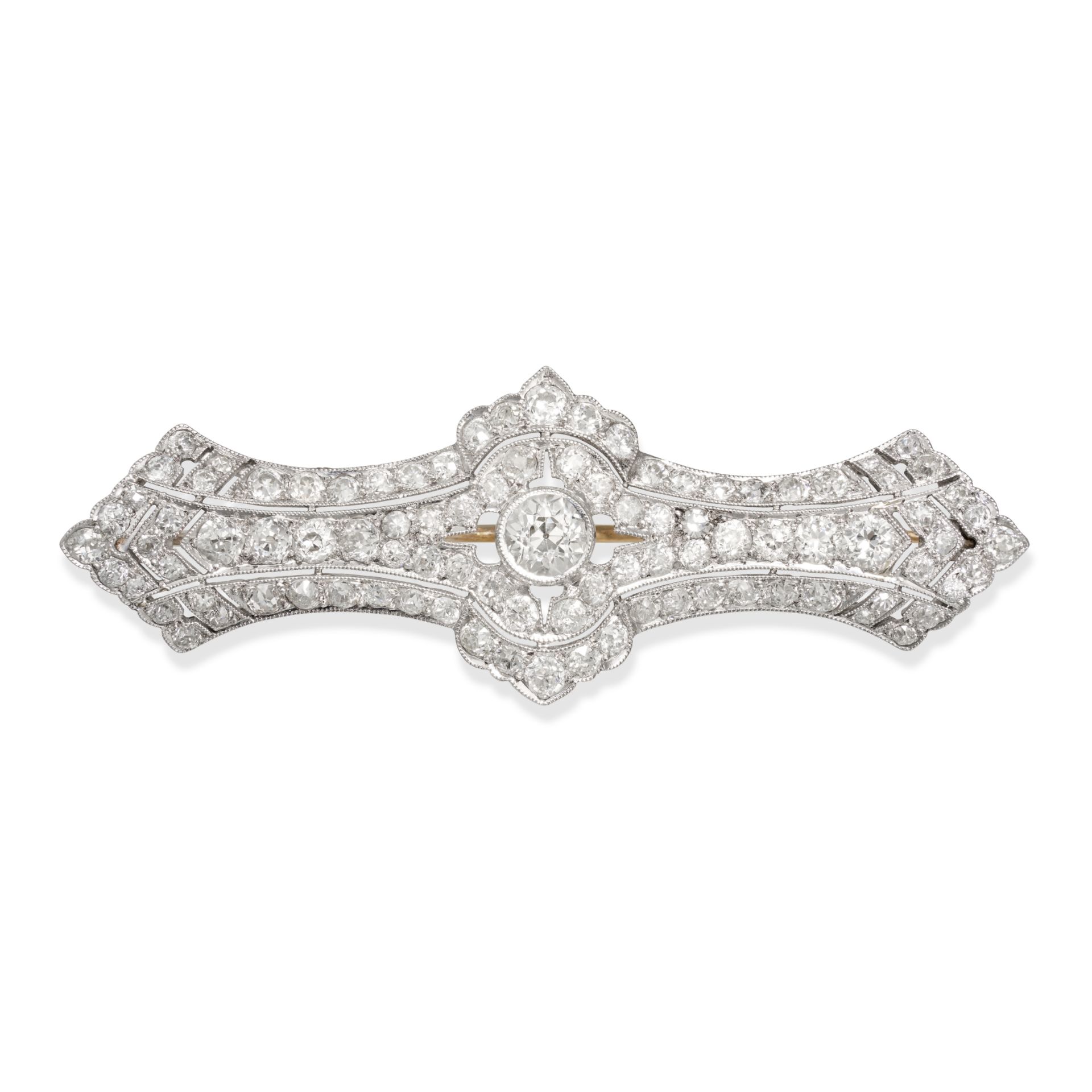 A DIAMOND BROOCH in platinum and white gold, the pierced geometric brooch set to the centre with ...