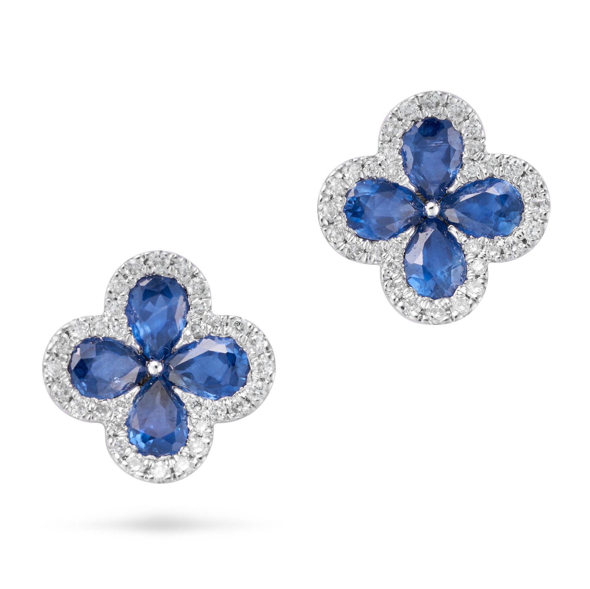 A PAIR OF SAPPHIRE AND DIAMOND FLOWER EARRINGS each set with four pear cut sapphires in a border ...