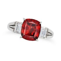 A GARNET AND DIAMOND THREE STONE RING set with a cushion cut garnet of 2.35 carats accented on ea...