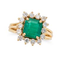 A COLOMBIAN EMERALD AND DIAMOND CLUSTER RING set with an octagonal step cut emerald of 2.31 carat...