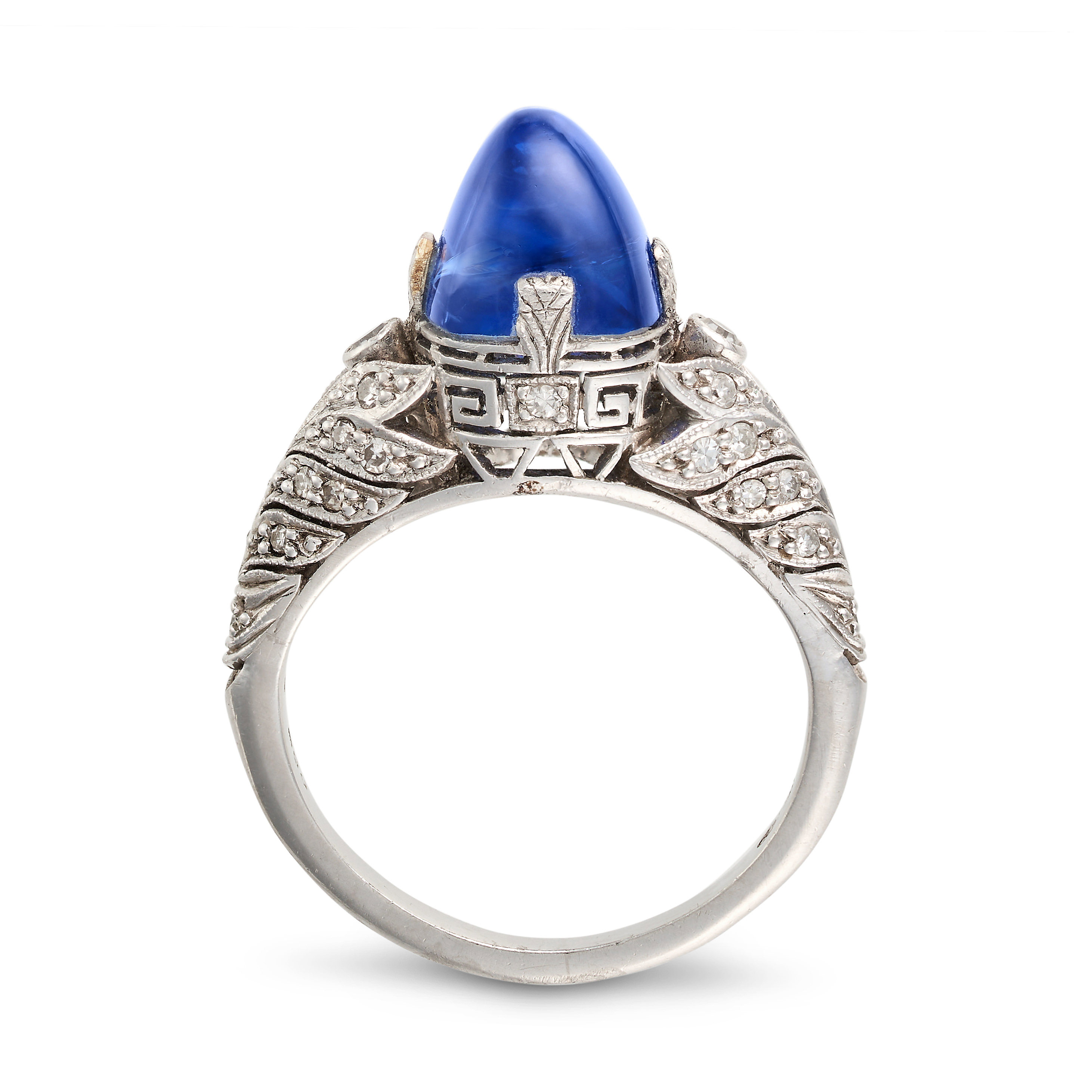 AN ART DECO KASHMIR SAPPHIRE AND DIAMOND RING in platinum, set with a sugarloaf cabochon sapphire...