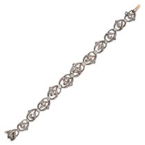 AN ANTIQUE FRENCH DIAMOND BRACELET in 18ct yellow gold and silver, comprising a row of scrolling ...