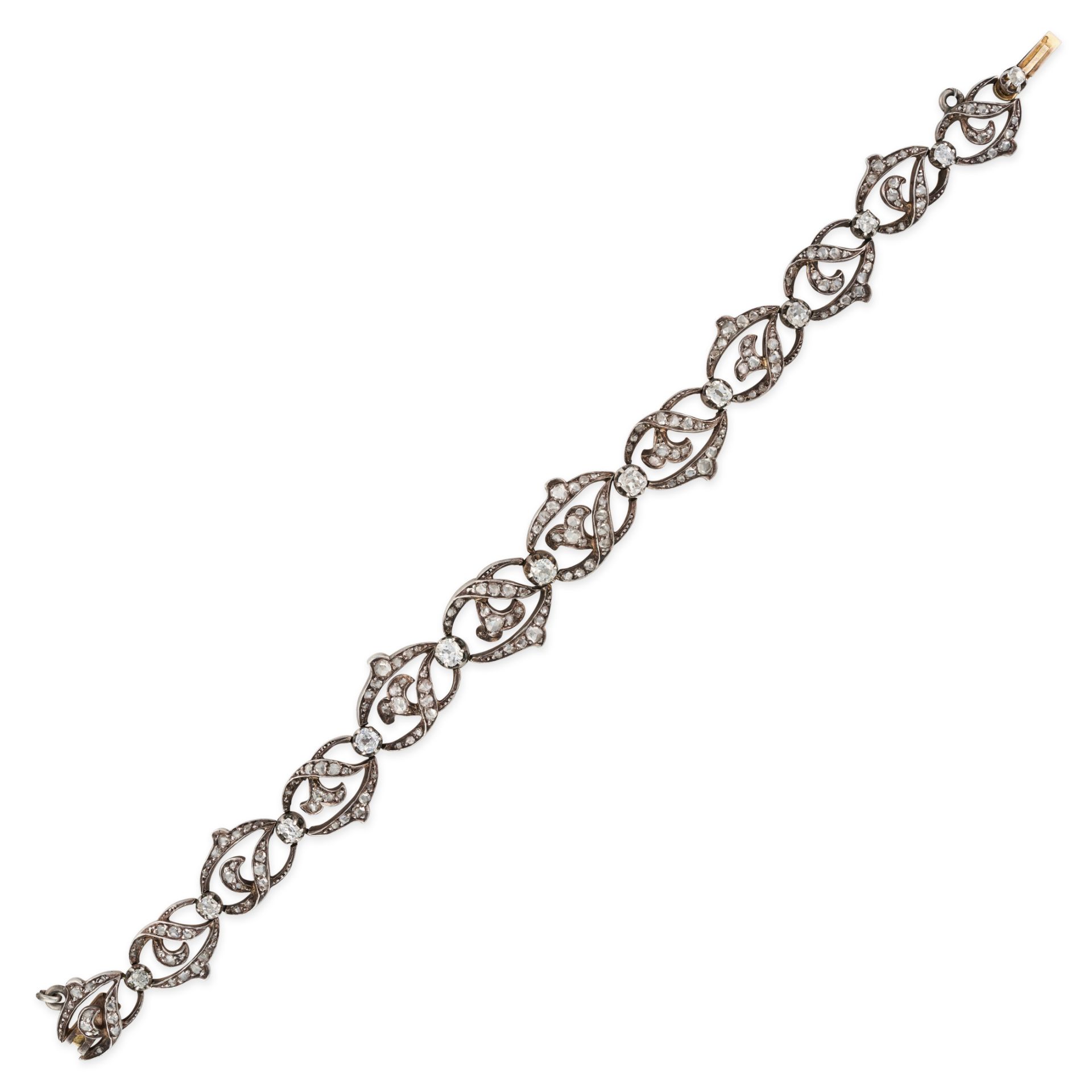 AN ANTIQUE FRENCH DIAMOND BRACELET in 18ct yellow gold and silver, comprising a row of scrolling ...