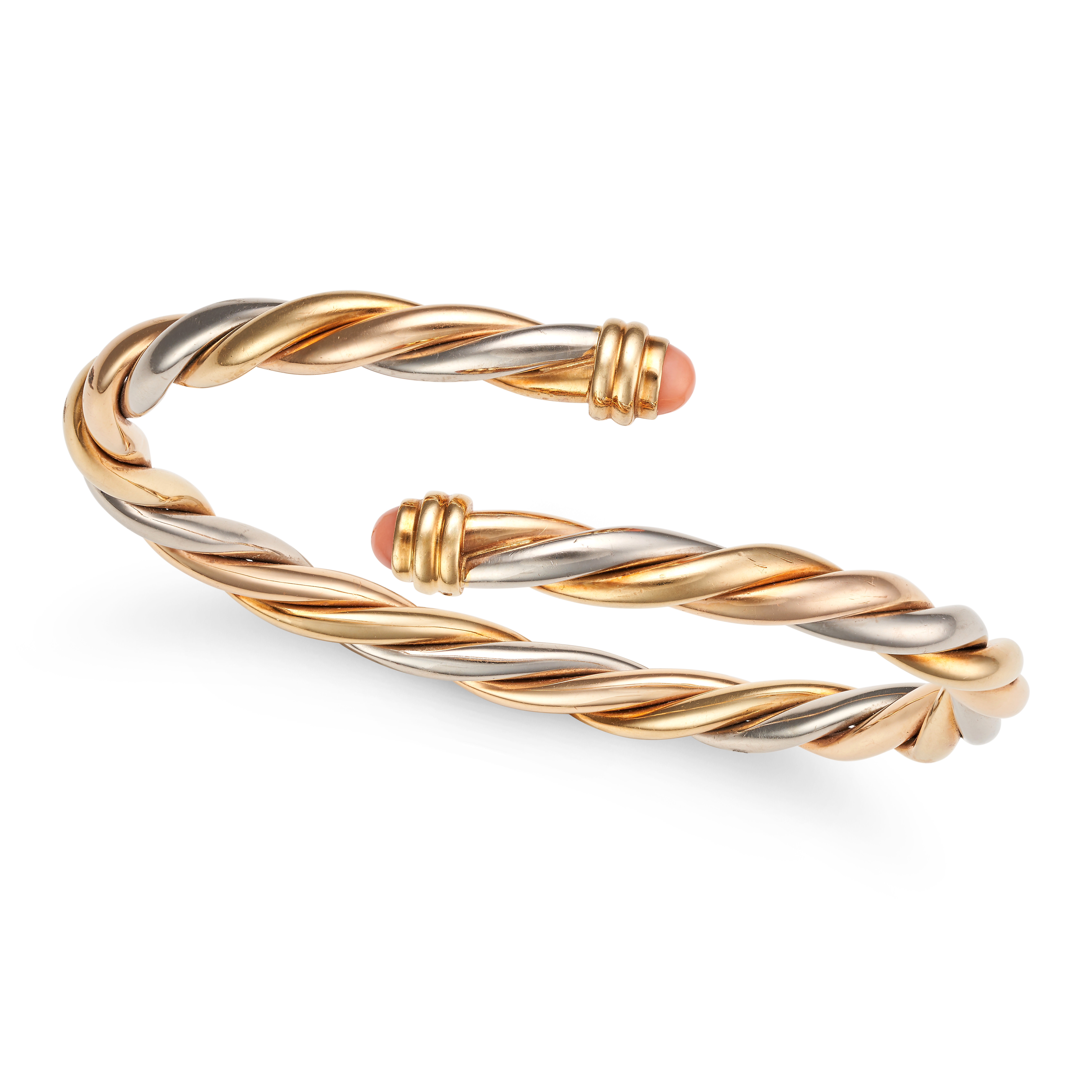 CARTIER, A TRICOLOUR GOLD AND CORAL BANGLE in 18ct yellow, white and rose gold, the open cuff ban...