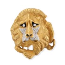 A DIAMOND AND ENAMEL LION BROOCH in yellow gold, designed as a lion, set with round brilliant and...