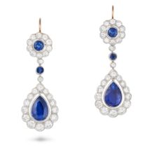 A FINE PAIR OF SAPPHIRE AND DIAMOND DROP EARRINGS each set with a round cut sapphire in a cluster...