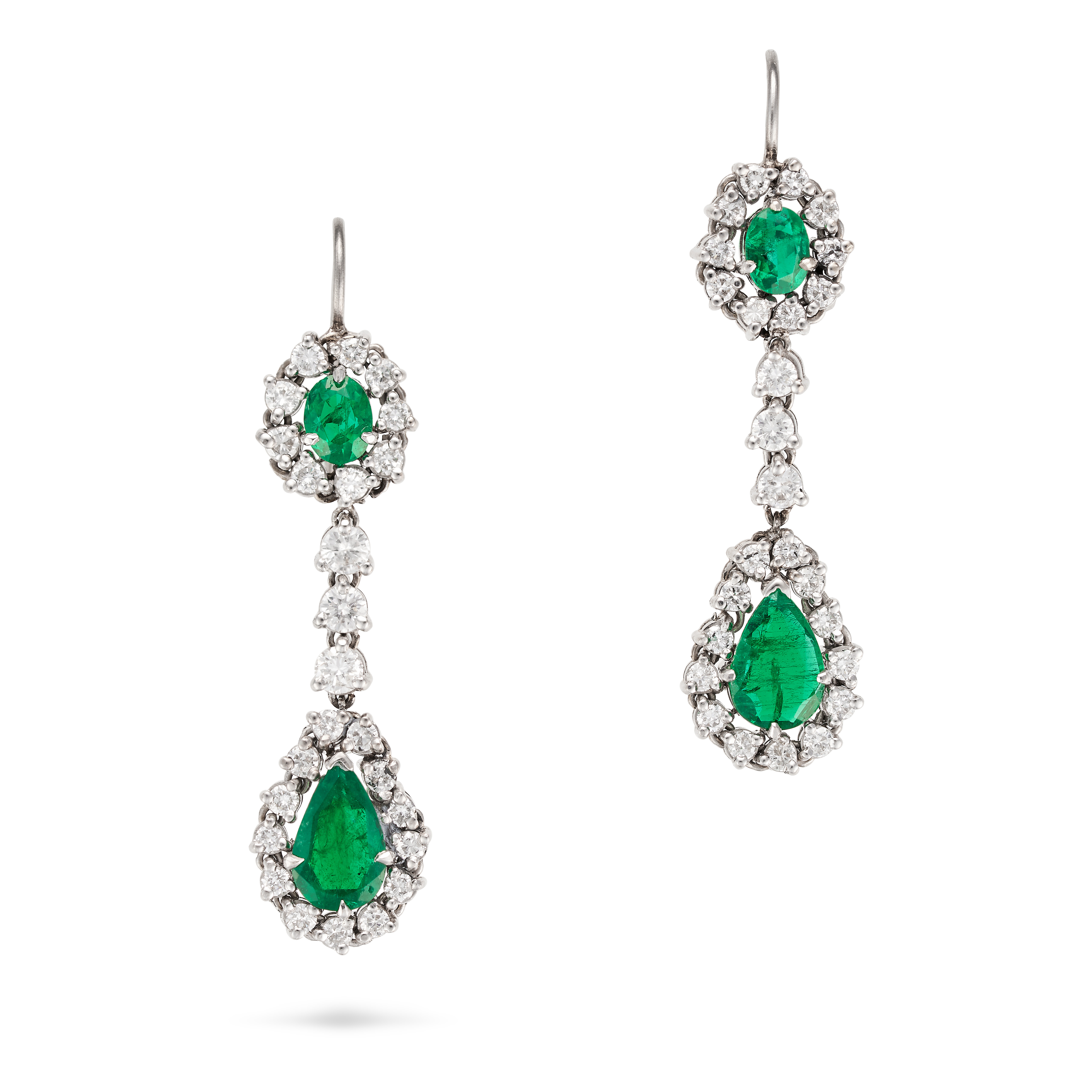 A PAIR OF DIAMOND AND EMERALD DROP EARRINGS in white gold, each comprising an oval cut emerald in...