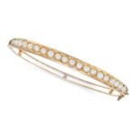 AN ANTIQUE PEARL BANGLE the hinged bangle set with a row of pearls, no assay marks, inner circumf...