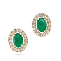 A PAIR OF EMERALD AND DIAMOND EARRINGS each set with a central oval cut emerald surrounded by a c...