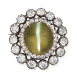 A FINE ANTIQUE CAT'S EYE CHRYSOBERYL AND DIAMOND CLUSTER BROOCH in yellow gold and silver, set wi...