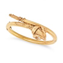 AN ANTIQUE ETRUSCAN REVIVAL GOLD RAM BANGLE in yellow gold, the hinged bangle terminating with a ...