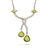 AN ANTIQUE PERIDOT AND DIAMOND PENDANT NECKLACE in yellow gold, the pendant set with two round pe...
