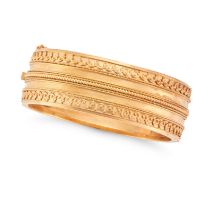 AN ANTIQUE ETRUSCAN REVIVAL BANGLE in yellow gold, the hinged bangle accented by rope and beadwor...