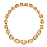 AN ANTIQUE CITRINE RIVIERE NECKLACE in yellow gold, comprising a row of graduating oval cut citri...