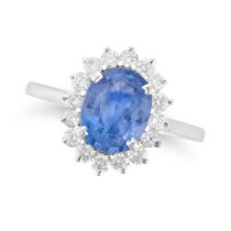 A SAPPHIRE AND DIAMOND CLUSTER RING set with an oval cut sapphire of approximately 2.90 carats in...