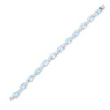 A BLUE TOPAZ AND DIAMOND BRACELET comprising a row of oval cut blue topaz, accented by heart shap...