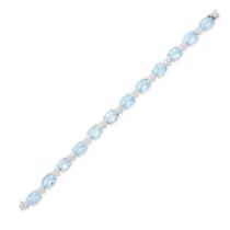 A BLUE TOPAZ AND DIAMOND BRACELET comprising a row of oval cut blue topaz, accented by heart shap...