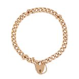 AN ANTIQUE PADLOCK BRACELET in 15ct yellow gold, comprising a curb link bracelet suspending a hea...