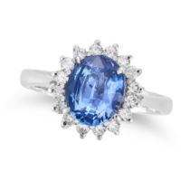 A SAPPHIRE AND DIAMOND CLUSTER RING set with an oval cut sapphire of 1.97 carats in a cluster of ...