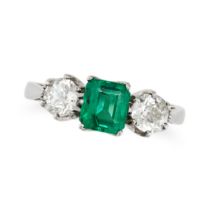 AN EMERALD AND DIAMOND THREE STONE RING in platinum, set with an octagonal step cut emerald of 1....