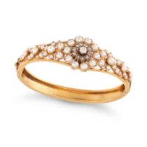 AN ANTIQUE DIAMOND AND PEARL BANGLE in yellow gold, the hinged bangle in foliate design, set with...