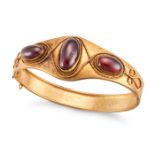AN ANTIQUE GARNET BANGLE the hinged bangle set with three oval cabochon garnets accented by ropew...