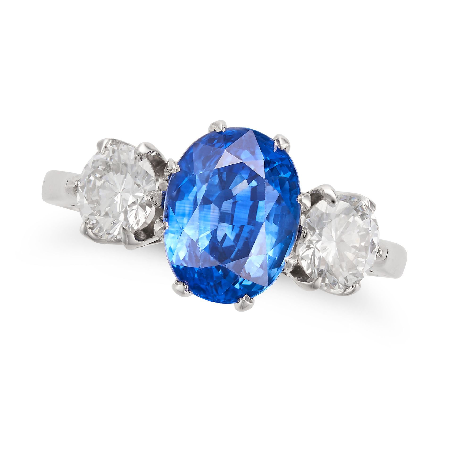 A SAPPHIRE AND DIAMOND THREE STONE RING in platinum, set with an oval cut sapphire of approximate...