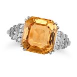 A TOPAZ AND DIAMOND RING set with an octagonal step cut topaz of approximately 4.70 carats, the s...