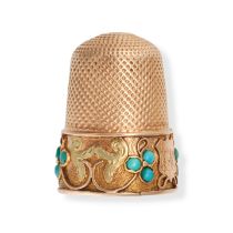 AN ANTIQUE TURQUOISE THIMBLE in yellow gold, accented by clover motifs set with round cabochon tu...