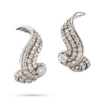 A PAIR OF DIAMOND EARRINGS each in scrolling design set throughout with round brilliant and singl...