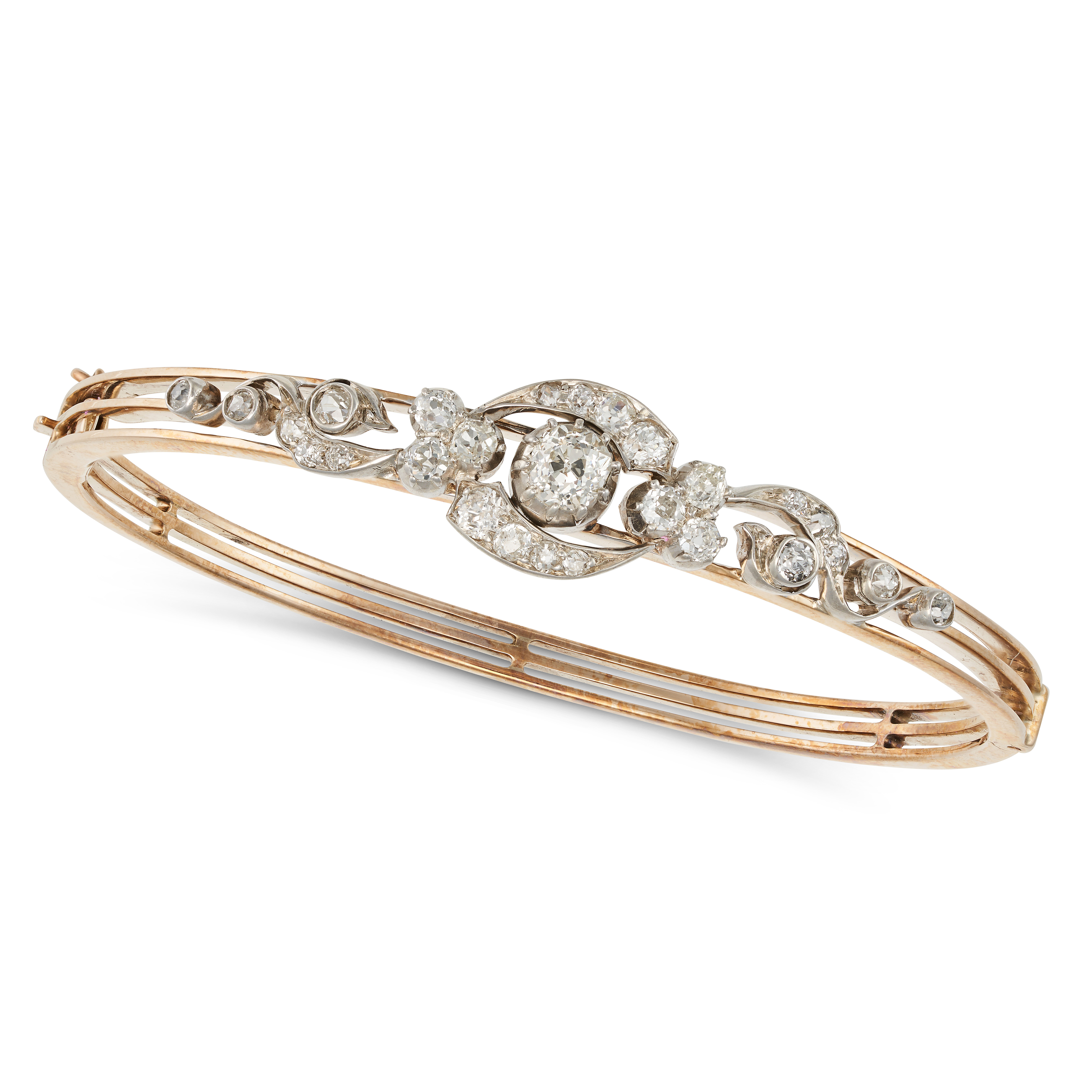 AN ANTIQUE VICTORIAN DIAMOND BANGLE in yellow gold, in a scrolling design set throughout with old...