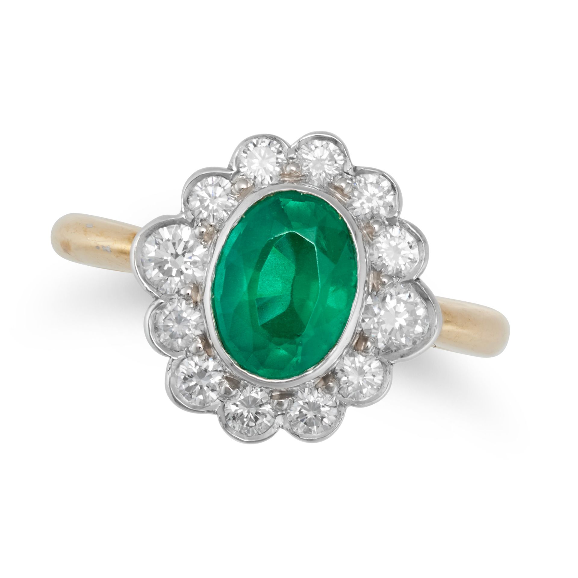 AN EMERALD AND DIAMOND CLUSTER RING in 18ct yellow gold, set with an oval cut emerald in a cluste...