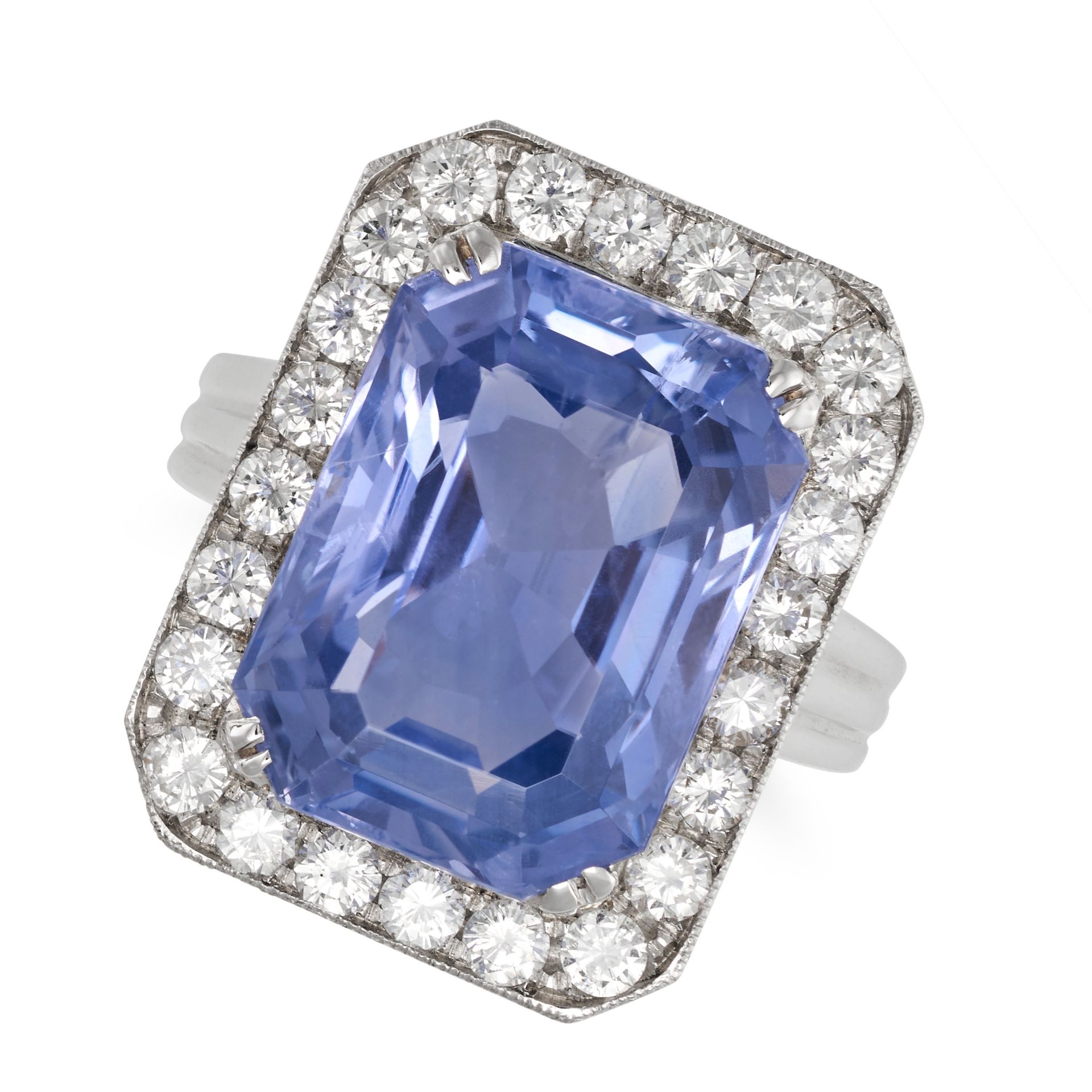 A CEYLON NO HEAT SAPPHIRE AND DIAMOND CLUSTER RING in white gold, set with an octagonal step cut ...