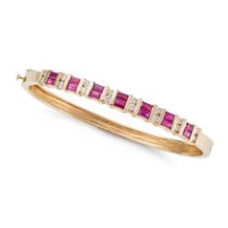 A RUBY AND DIAMOND BANGLE the hinged bangle set with rectangular step cut rubies accented by pair...