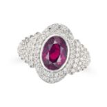 A RUBY AND DIAMOND DRESS RING set with an oval cut ruby of approximately 2.83 carats in a border ...