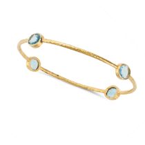 A BLUE TOPAZ BANGLE the closed bangle set with four oval cut blue topaz, stamped 18K, inner circu...