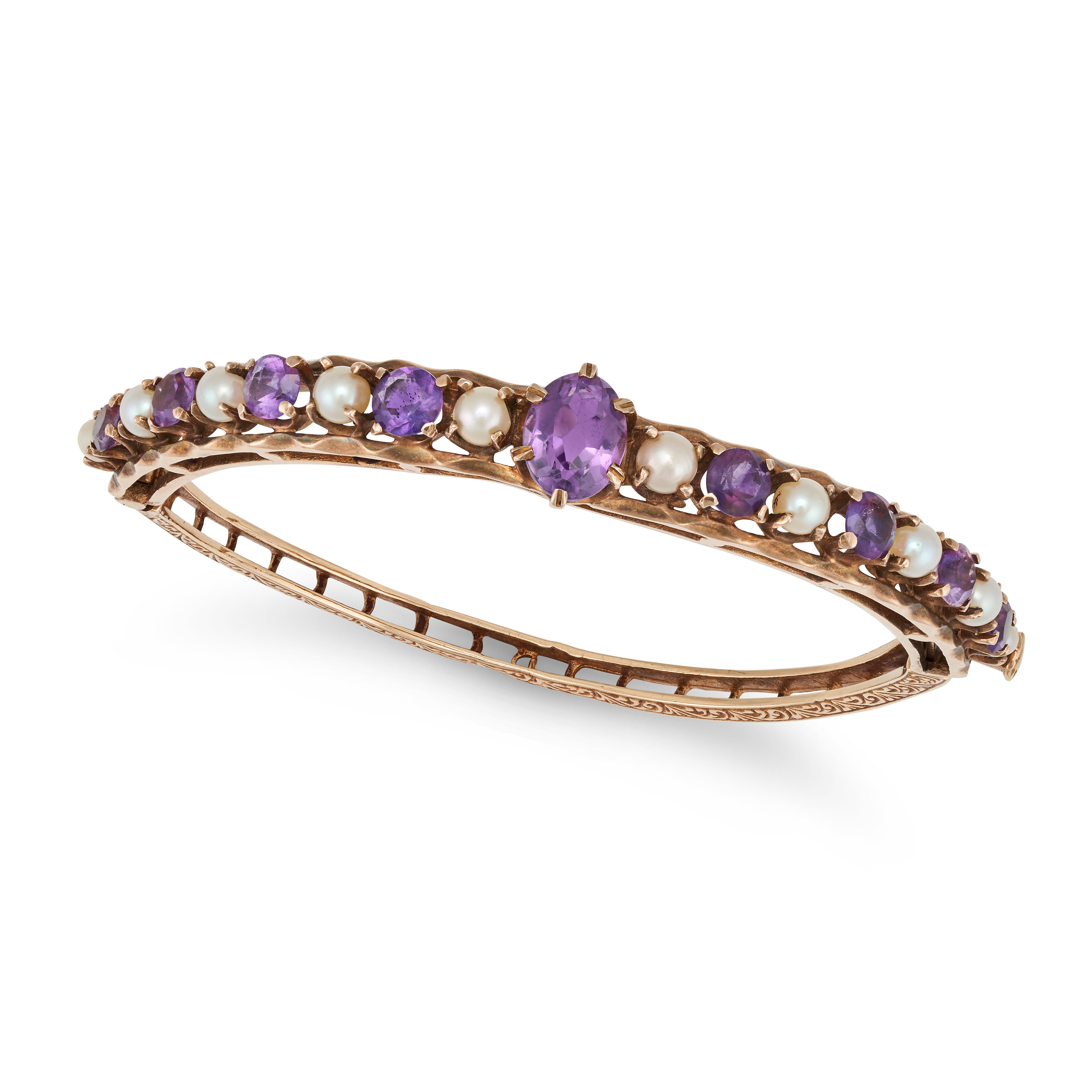 AN ANTIQUE AMETHYST AND PEARL BANGLE in 9ct yellow gold, the hinged bangle set with an oval cut a...