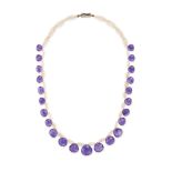 NO RESERVE - AN AMETHYST AND PEARL NECKLACE comprising two rows of seed pearls, suspending briole...