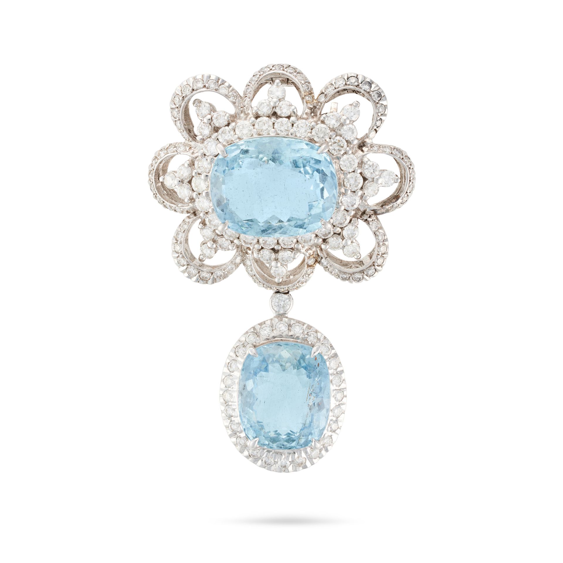 AN AQUAMARINE AND DIAMOND BROOCH / PENDANT set with a cushion cut aquamarine in a stylised border...