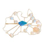 AN OPAL AUSTRALIA BROOCH designed as the outline of Australia, set to the centre with a fancy sha...