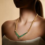 AN EMERALD AND DIAMOND NECKLACE comprising a row of circular links, suspending a geometric pendan...