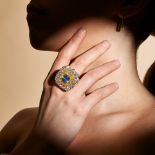 A CEYLON NO HEAT SAPPHIRE AND DIAMOND DRESS RING set with a cushion cut sapphire of 6.88 carats i...