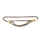 CHANEL, A CHAIN AND LEATHER BELT comprising a chain link belt intertwined with black leather, thr...