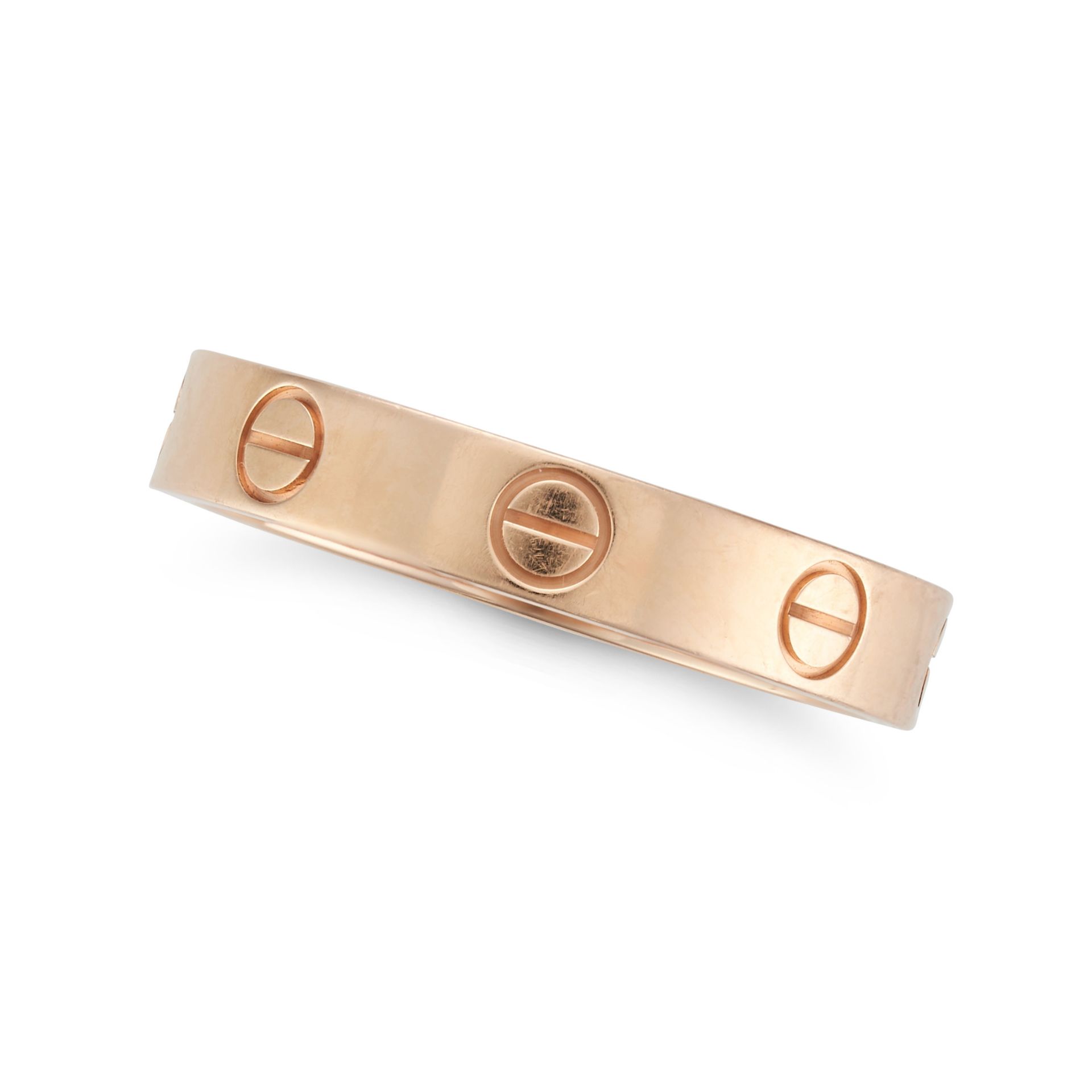 CARTIER, A LOVE RING in 18ct rose gold, the band punctuated by screw head motifs, signed Cartier ...