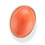 A CORAL RING set with a large cabochon coral, the mount with engraved foliate details, stamped 75...